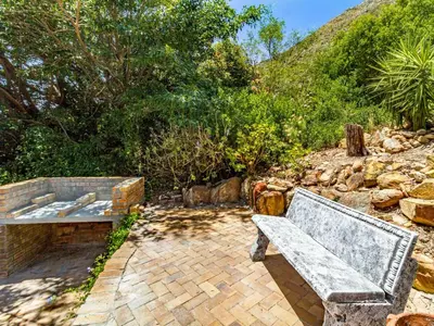 a stone bench sitting on a brick patio at 5 Suikerbossie in Gordonʼs Bay
