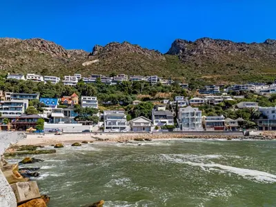 a view of a beach with houses and the water at 5 Suikerbossie in Gordonʼs Bay