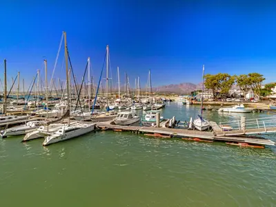 a group of boats docked at a dock in the water at 5 Suikerbossie in Gordonʼs Bay