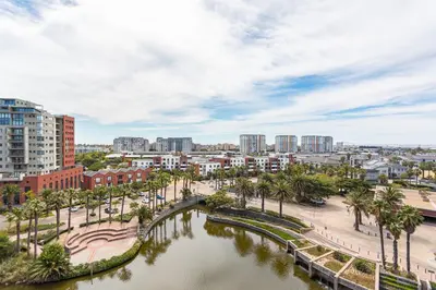 a city with a river and palm trees and buildings at Knightsbridge 702W by CTHA in Cape Town