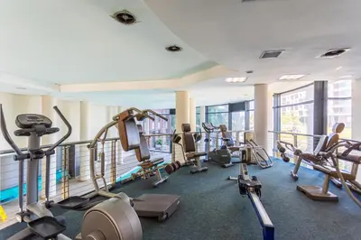 a gym with treadmills and cardio equipment in a building at Knightsbridge 702W by CTHA in Cape Town