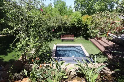 a garden with a bench and a swimming pool at Greyton Hideaway-on-Disa in Greyton