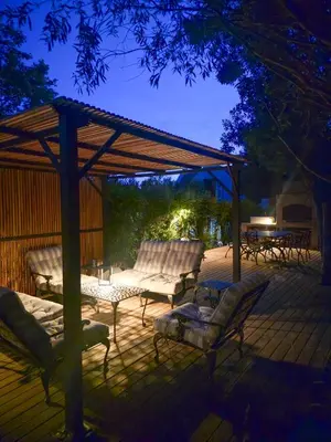 a deck with two chairs and a gazebo at Greyton Hideaway-on-Disa in Greyton
