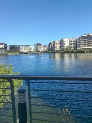 a view of a river with buildings in the background at Classy Budget Apartment in Tyger Valley