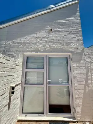 a window on the side of a house at The Sultan Cottage in Stellenbosch