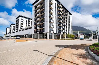 an empty street in front of a large building at 721 Riverlands - Lux 2 Bedroom Apartment in Cape Town