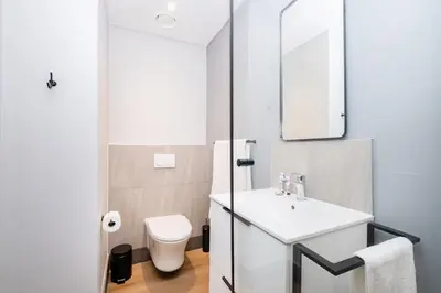 a bathroom with a white sink and a toilet at 721 Riverlands - Lux 2 Bedroom Apartment in Cape Town