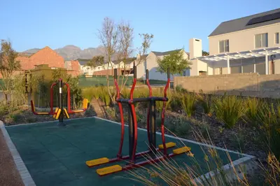 a playground with two play equipment in a yard at Casa Voliere in Stellenbosch