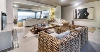 a living room with a couch and a table at Exclusive Estate, Panoramic Beauty, Watersports in Lake Marina