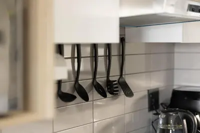 a row of utensils hanging on a kitchen wall at Durbanville Daydream in Durbanville