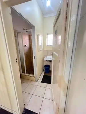 a bathroom with a sink and a mirror at Heritage lodge in Cape Town