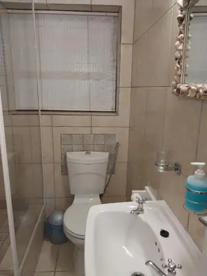 a bathroom with a toilet and a sink and a tub at Catch And Release Hermanus in Hermanus