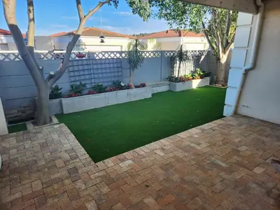 a backyard with a yard of green grass at Home in Somerset Ridge in Somerset West