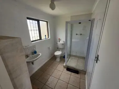 a bathroom with a shower and a toilet and a sink at The Sandpiper - The Alikreukel , Pringle Bay in Pringle Bay