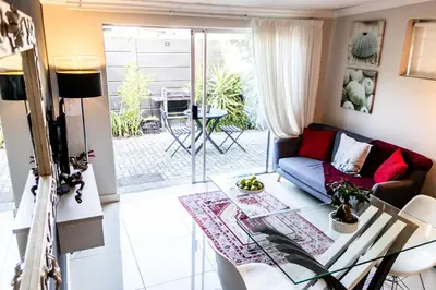 a living room with a couch and a table at Seagull Apartment Hermanus in Hermanus