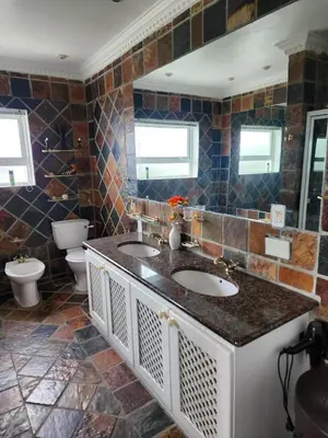 a bathroom with two sinks and a toilet at Zoute Zoene in Kleinmond