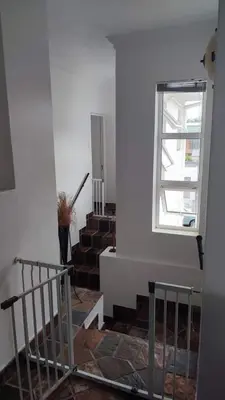 a staircase in a building with a window at Zoute Zoene in Kleinmond