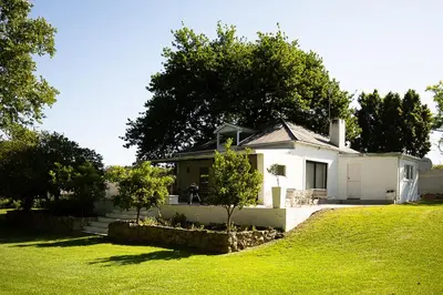 a white house with a grassy yard in front of it at Galileo Farm in Elgin