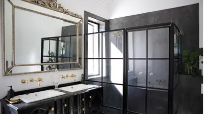 a bathroom with two sinks and a large mirror at Château Famille in Franschhoek