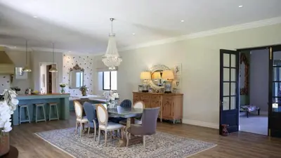 a kitchen and dining room with a table and chairs at Château Famille in Franschhoek