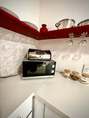 a toaster oven sitting on a counter in a kitchen at Ebgow Cottage in Cape Town