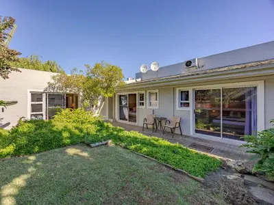 a house with a lawn in front of it at Hajo's Lodge & Spa in Cape Town