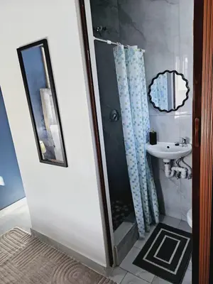 a bathroom with a shower and a sink at En suite in Cape Town