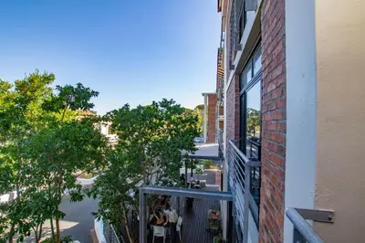 a balcony of a building with a view of a street at CAG Bosman's Crossing Stellenbosch in Stellenbosch