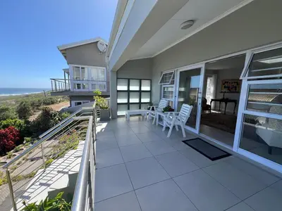 a balcony of a house with a view of the ocean at Vermont Hermanus Flatlet in Hermanus