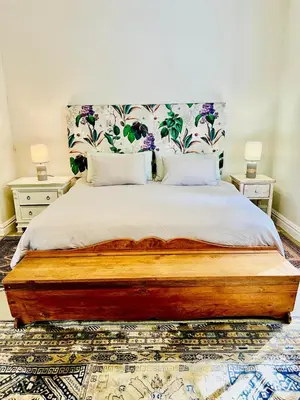 a bedroom with a large bed with two night stands at Sunny Poolside Escape in Somerset West in Somerset West