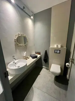 a bathroom with a sink and a toilet and a mirror at Stay on Main 2 in Paarl