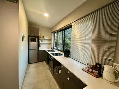 a kitchen with a counter and a large window at Stay on Main 2 in Paarl