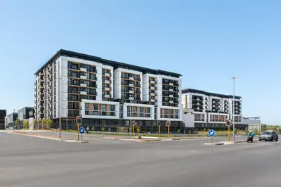a large building on the side of a street at Sunbird Apartments in Cape Town