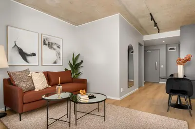 a living room with a couch and a table at Sunbird Apartments in Cape Town
