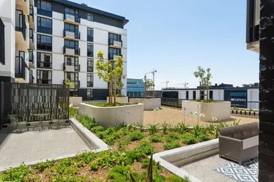 a garden in the middle of a building at Sunbird Apartments in Cape Town