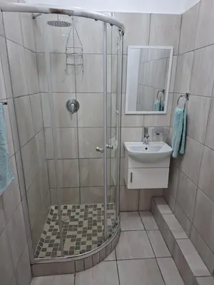 a bathroom with a shower and a sink at MDA Myburgh in Brackenfell