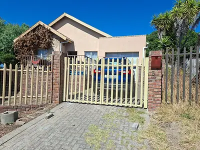 a wooden fence in front of a house at MDA Myburgh in Brackenfell