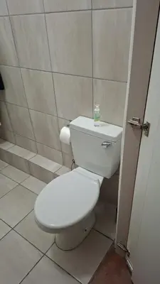 a bathroom with a white toilet in a room at MDA Myburgh in Brackenfell