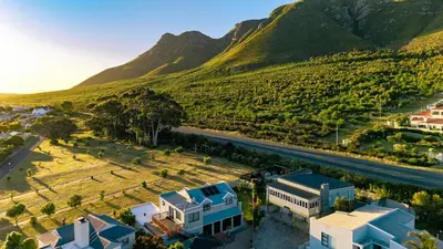 an aerial view of a house in front of a mountain at Onrus Family Retreat in Hermanus