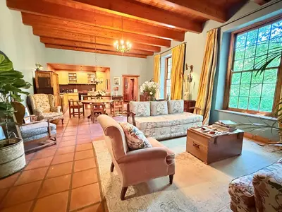 a living room with a couch and a table at Die Jonkmanshuis in Stellenbosch