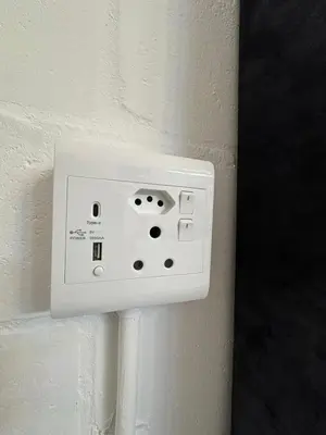 a white electrical outlet on a white wall at Studio Seabiscuit in Cape Town