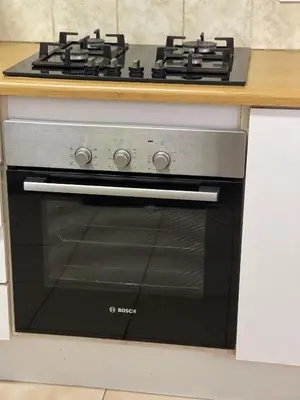 a stove top oven sitting under a counter in a kitchen at The Garden House in Hermanus