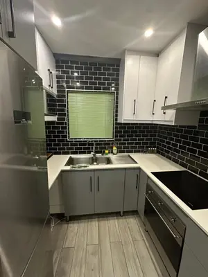 a kitchen with white cabinets and a sink at 29 on Windsor-2 Bedroom House in Silver Sands