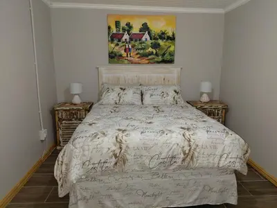 a bed in a bedroom with two night stands at Place of Old D in Eersterivier