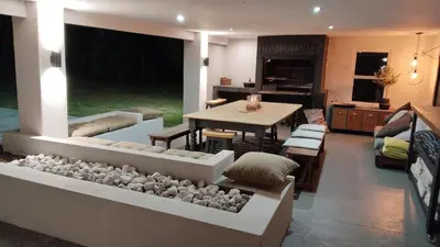 a living room with a table and a dining room at 6 on Krisant-Durbanville in Oakdale