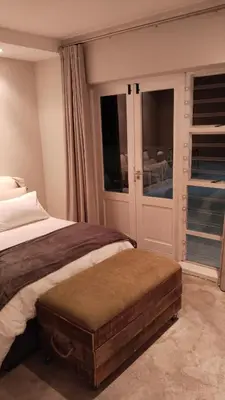 a bedroom with a bed and a large window at 6 on Krisant-Durbanville in Oakdale