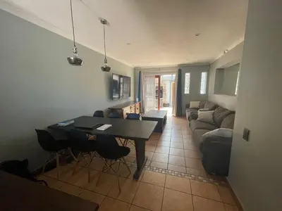 a living room with a table and a couch at Vynhubia in Monte Vista