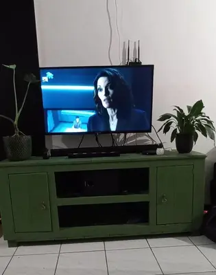 a flat screen tv sitting on top of a green cabinet at A Stone's Throw away in Cape Town