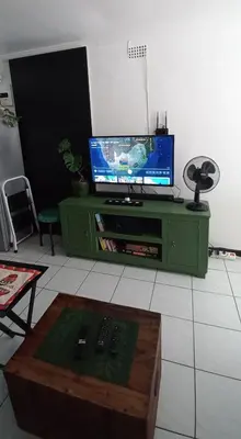 a living room with a tv and a table at A Stone's Throw away in Cape Town