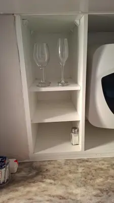 two wine glasses sitting on shelves in a cabinet at MDA Myburgh in Brackenfell